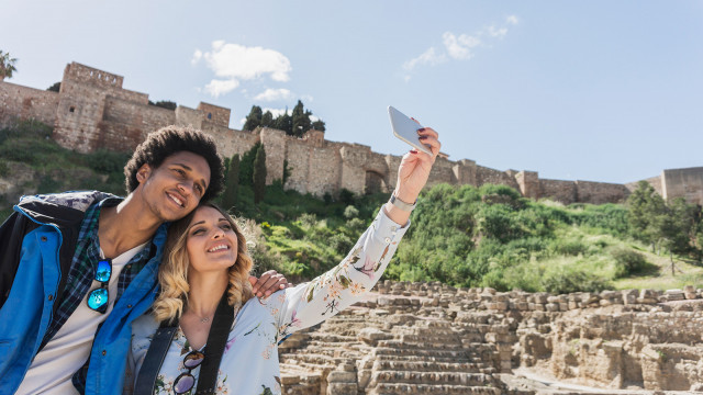 Interracial couple of friends travelers taking selfie