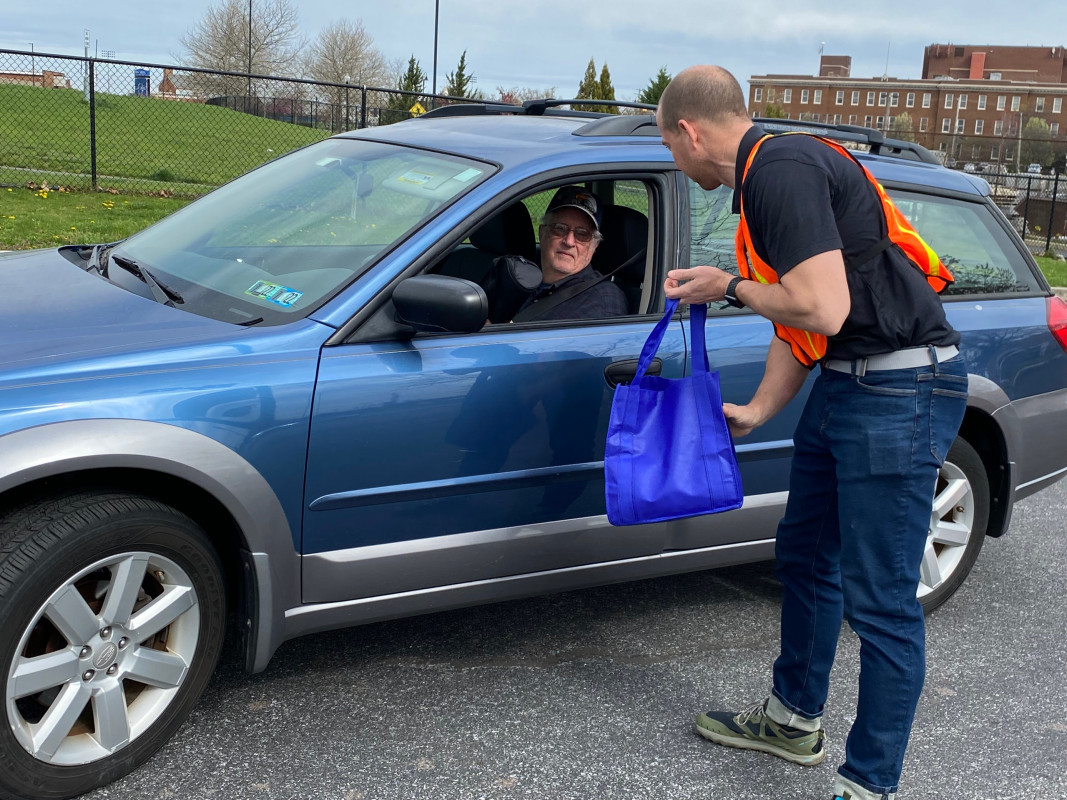 Nate Pigott Helping AAA Member at Shredding Event
