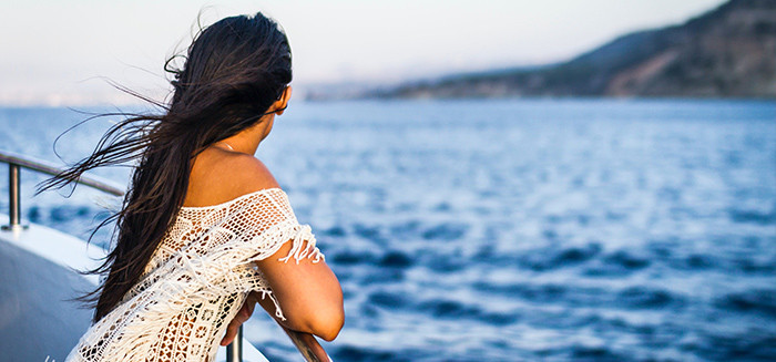 woman looking over rail of boat