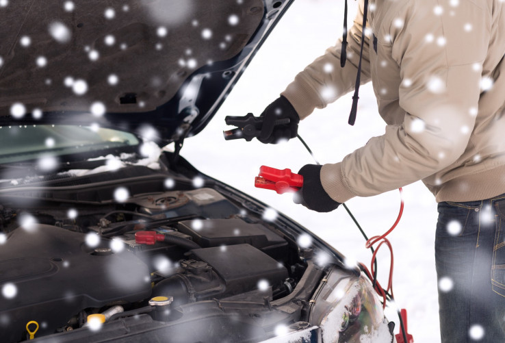 Person jumping car battery