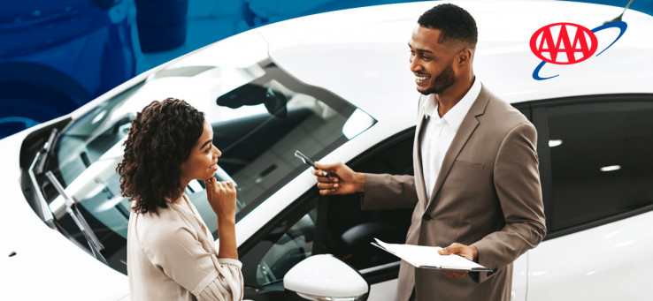 Woman discussing purchase with car salesman