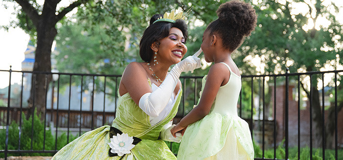 Princess Tiana interacting with a little girl