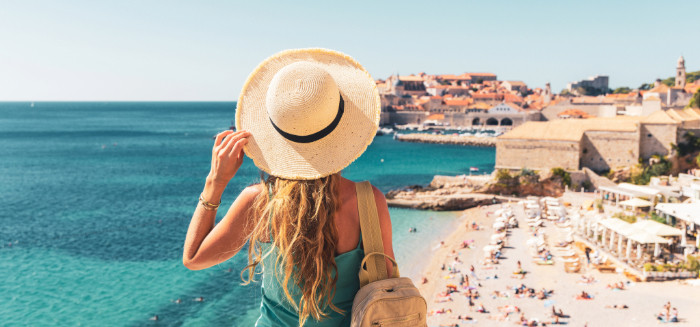 girl with hat looking at coast