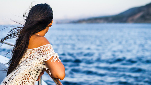 woman looking over rail of boat