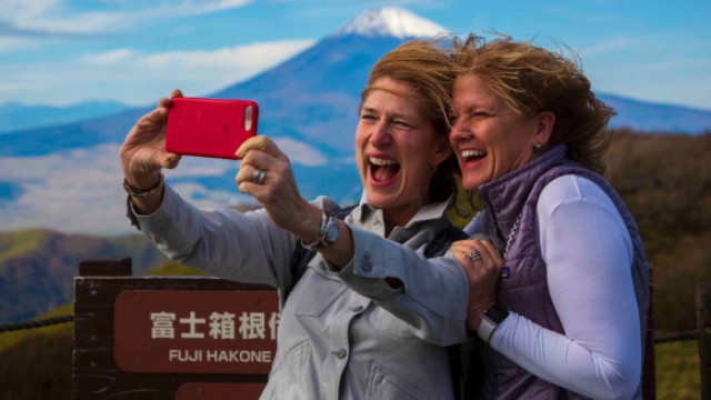 Women taking photo in front of Mt. Fiji