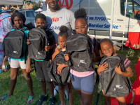 children holding backpacks