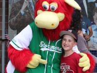 Silo the cow with boy at Lancaster baseball