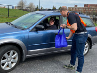 Nate Pigott Helping AAA Member at Shredding Event