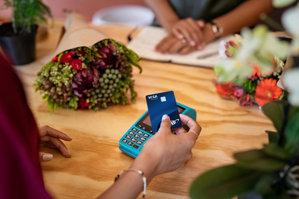 Customer using credit card for payment at flower shop