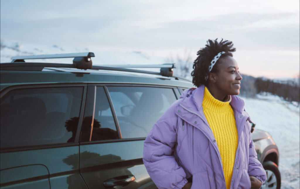 Women standing next to her vehicle