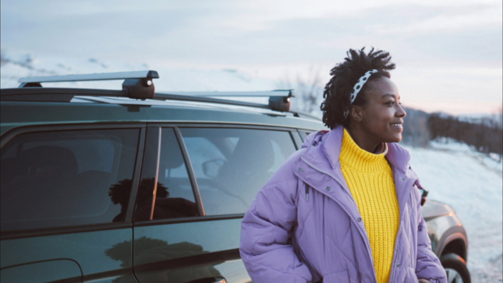 Women standing next to her vehicle