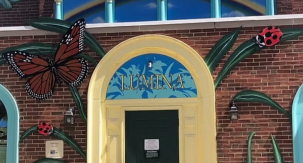 Luina sign over yellow doorway at the Lumina Center.