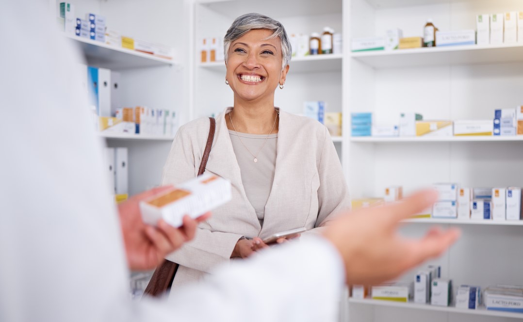 Woman in Pharmacy chatting with person in white coat