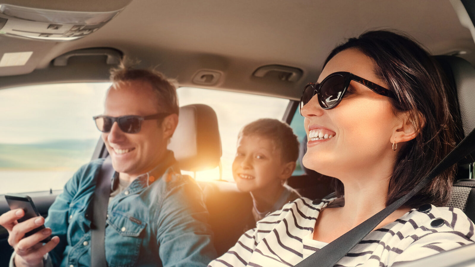 mother, father, and son in car