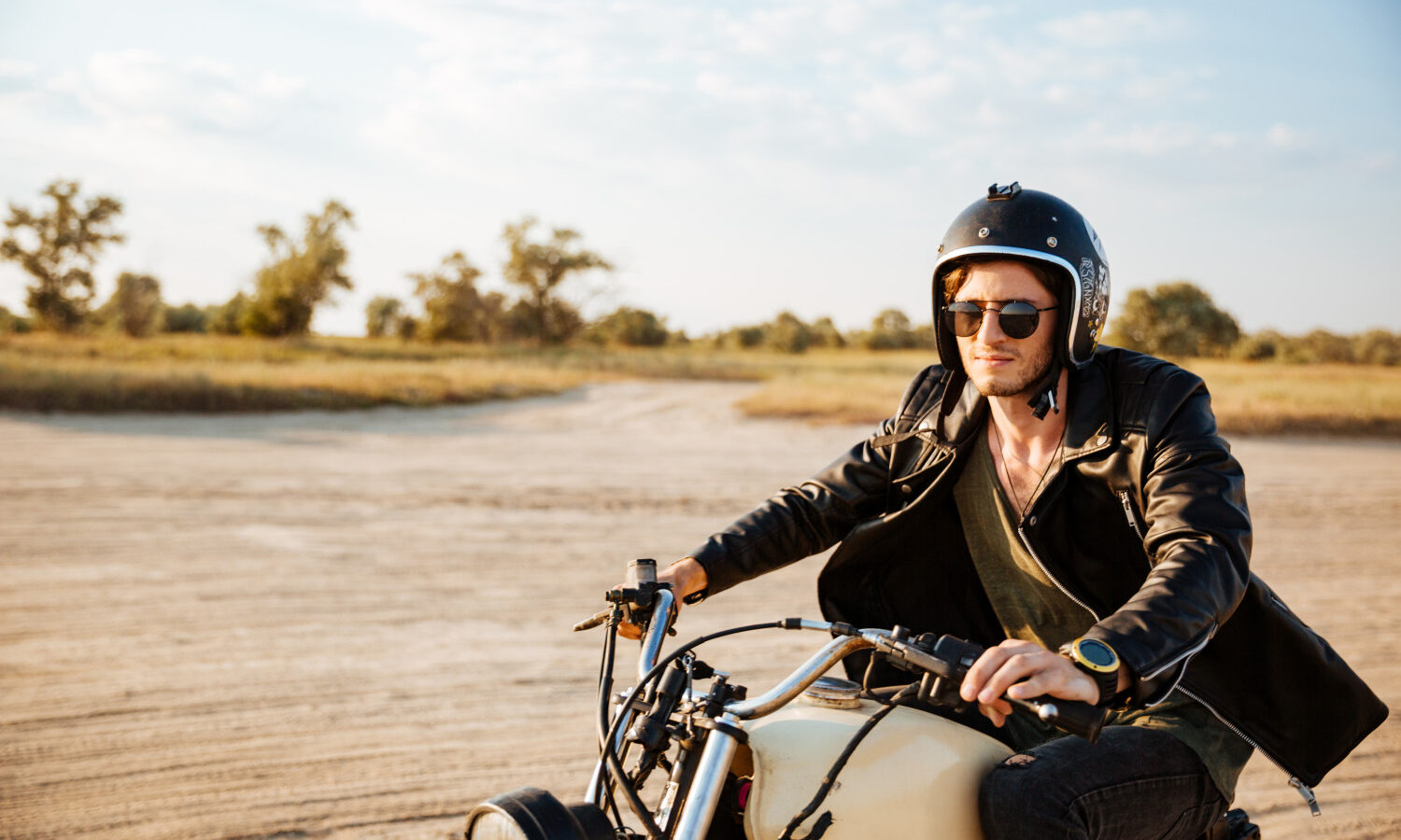 man driving retro motorcycle
