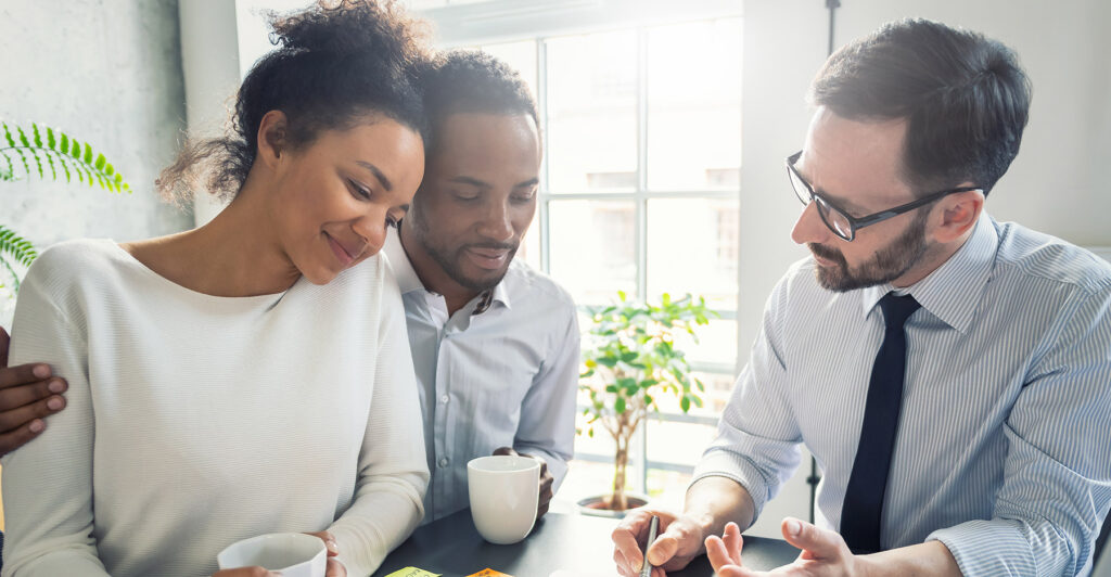 a couple meeting with an insurance agent