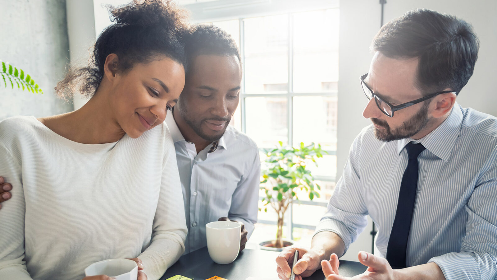 a couple meeting with an insurance agent