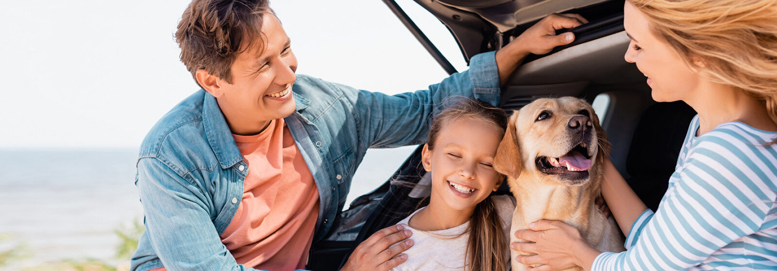 Family at the beach with their pet dog