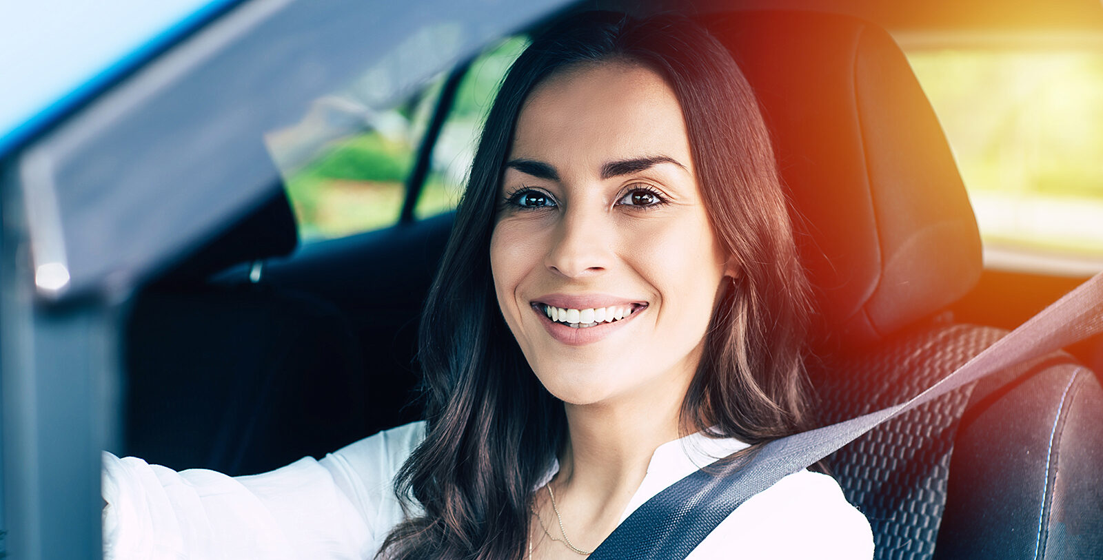 woman smiling driving car